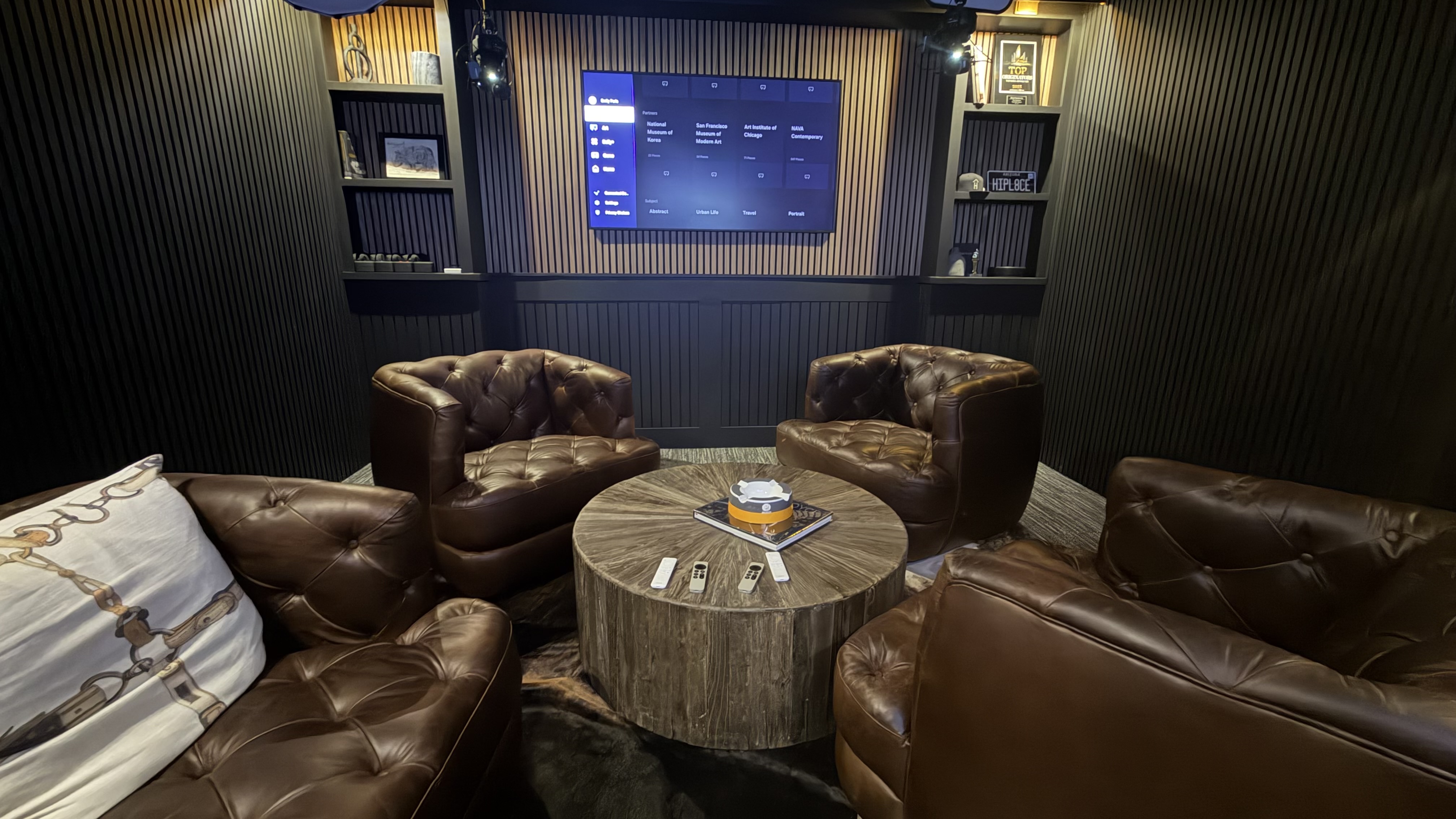 High Place Studio interior lounge with tufted leather seating and a large display
